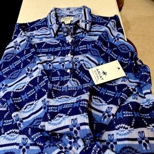 Brand new Ariat western shirt with paralyzed snap buttons .